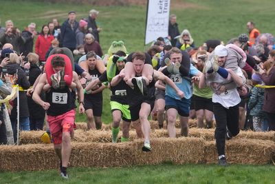 Will you carry me? Couples dash to be crowned winners of UK Wife Carrying Race