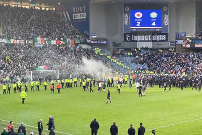 Moment Celtic and Rangers fans clash on pitch after penalty knockout