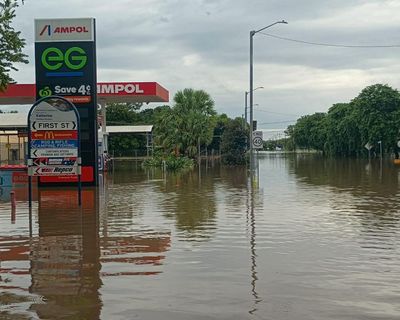 ‘A saltwater crocodile on the AFL oval’: worst flooding in decades inundates NT as residents urged to avoid water