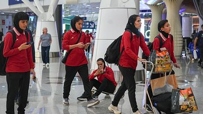 Iranian women’s football team seen at Malaysian airport as they prepare to head home