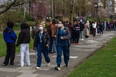 Hundreds of face mask-wearing students queue after deadly meningitis outbreak