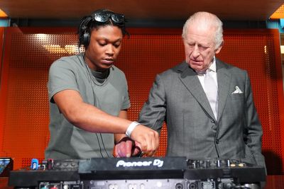 King Charles takes a spin on DJ decks during visit to Manchester