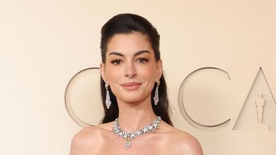 Anne Hathaway stuns in spring florals for her first Oscars in over a decade; her Valentino dress was quite the showstopper