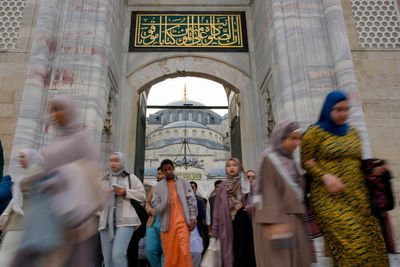 Muslims celebrate Eid al-Fitr as Middle East conflict casts a shadow