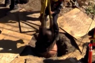 Man is lifted out of 15-foot hole in construction site by firefighters