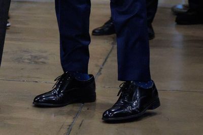 Trump’s beloved – and sometimes oversized – shoes that he gifts to his MAGA friends aren’t even made in America