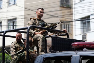 Rio police pull 4 officers from street duty in a probe into a deadly raid