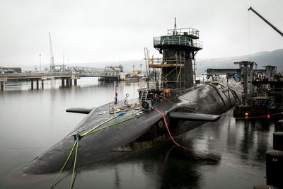 Iranian man and Romanian woman charged after submarine base incident