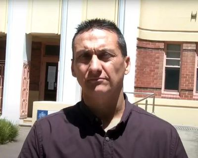 Fugitive emerged from building holding weapon before being shot dead, commissioner says – as it happened