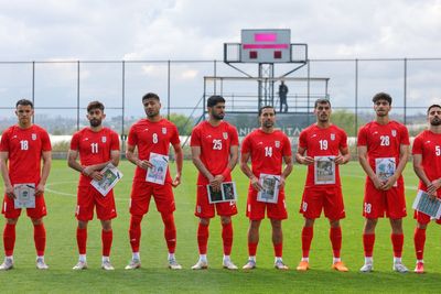 Iran footballers hold up pictures of children killed in US-Israel air strike in front of Trump ally FIFA chief