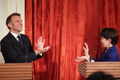 Manga fan Emmanuel Macron strikes Dragon Ball pose with Japanese prime minister