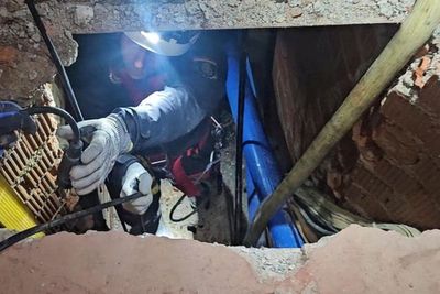 Underground drug-smuggling tunnel with rail system and cranes uncovered by police