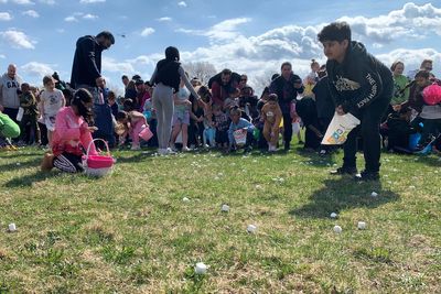 Thousands of marshmallows fall from helicopter as children scramble at Easter event