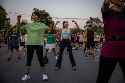‘There’s more to life than work’: Bangkok’s young people embrace mass outdoor aerobics sessions
