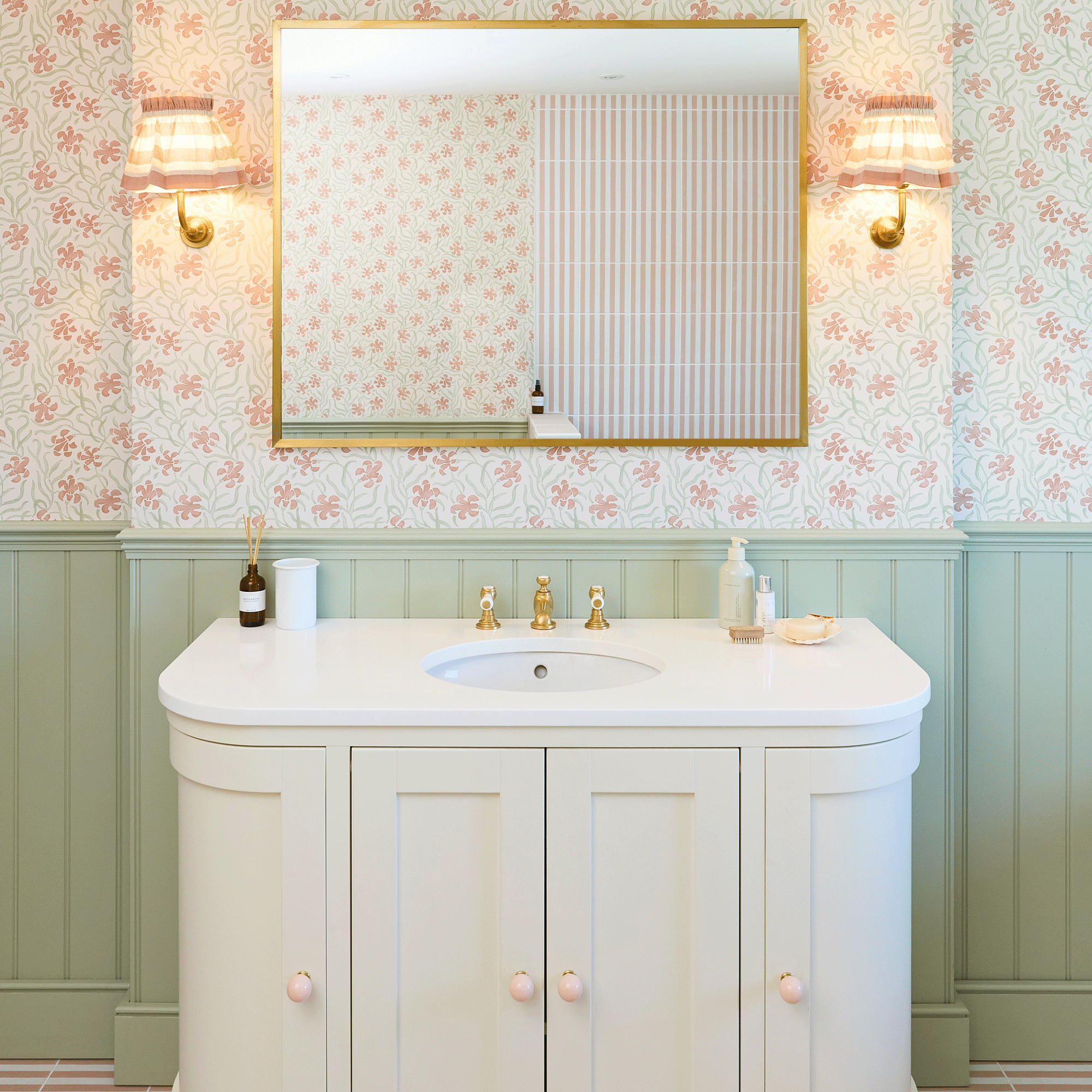This bathroom took a risk mixing patterned tiles and wallpaper, and the finished result is beautiful