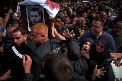 Lebanese bury 13 officers killed by Israel as grief and rage surge ahead of talks in the US