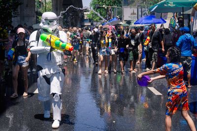 People spray water to celebrate the Thai New Year during the Songkran water festival, in photos