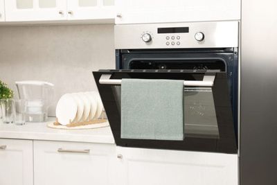 If You Have a Towel on Your Oven Door, Remove It Now—Experts Say It’s a Fire Risk