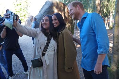 Harry and Meghan pose for selfies with public during walking tour