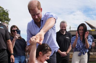 Harry dances with Australian girl before sailing around Sydney Harbour on latest leg of tour