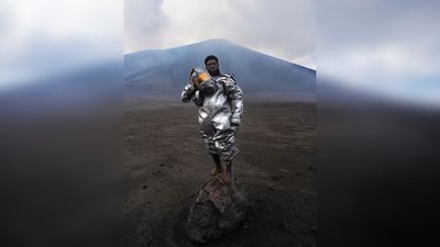 "There was ash billowing out from the volcano, it was sulphuric acid," says the photographer behind award-winning volcanologist portrait – but why is he barefoot on a rock?