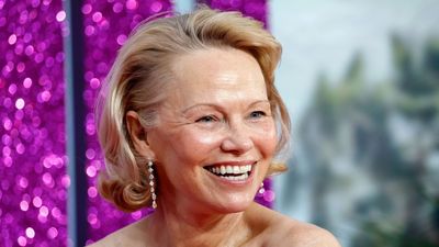 Pamela Anderson proves you can never go wrong with a straight-leg jeans, jumper and white trainer outfit formula