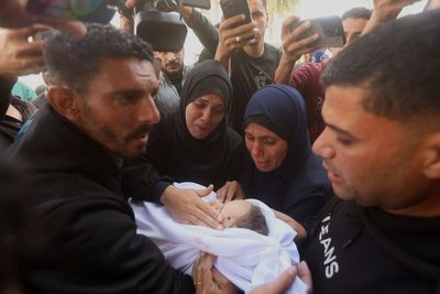 Palestinians hold funerals for pregnant woman and her children killed in Israeli strikes