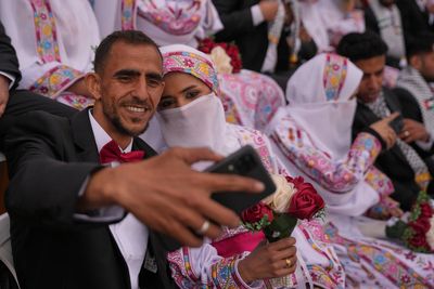 Photos show Palestinian couples celebrating a mass wedding in Gaza