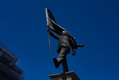 Banksy confirms a new statue in central London of a man blinded by a flag is his work