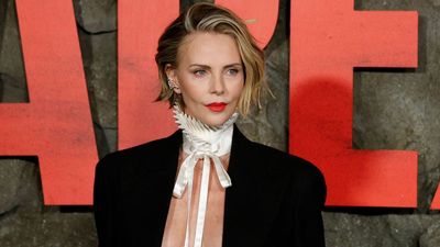Charlize Theron doesn't see herself living with a partner again, but they can 'buy the house down the street'