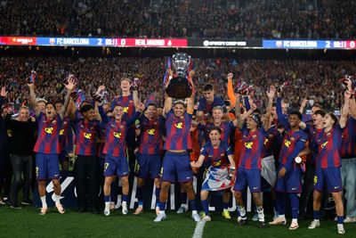 Watched by its grieving coach, Barcelona retains Spanish league title by beating rival Real Madrid
