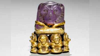 Lion's head pendant: An ancient Egyptian board game piece that was later repurposed into a magical religious object with baboons