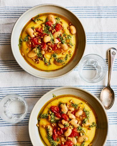 Rukmini Iyer’s quick and easy recipe for cheesy polenta with tomatoes, butter beans and pesto