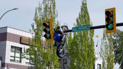 A Driver Turned And Couldn't See. Then A Motorcyce Ended Up Dangling From A Traffic Light Pole