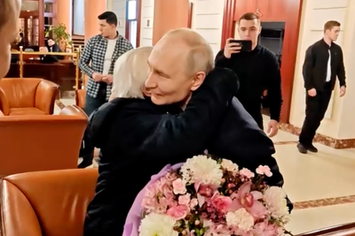 Putin hugs former high school teacher in new Kremlin video