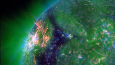Eruption blows hole in sun's atmosphere, unleashing solar flare and potentially triggering northern lights