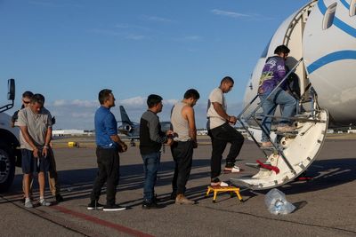 ICE strapped down immigrants for 51-hour plane trip with drop-offs in six countries during record month for deportation flights, report finds