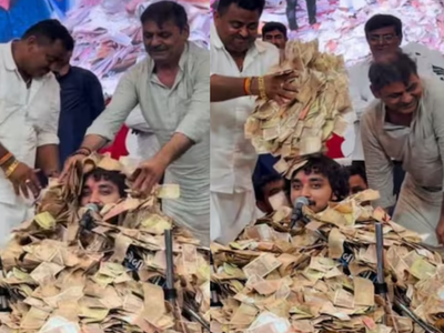 Viral Video: Devotees rain lakhs on Gujarati singer until he disappears under cash, but he keeps performing without missing a beat
