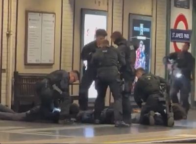 Armed Met Police officers storm Tube platform as they arrest three suspects
