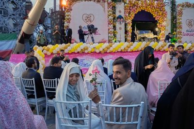 Photos of a mass wedding and a colorful missile at Tehran's 'Sacrifice for Iran' ceremony