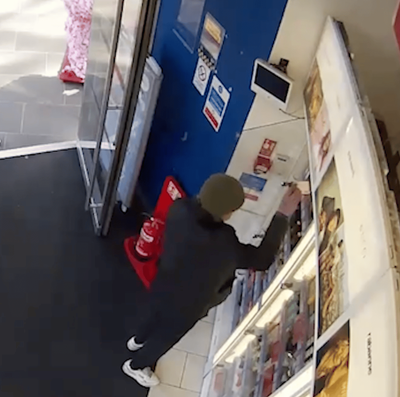Moment prolific shoplifter casually stuffs bottles of perfume into his pockets in central London