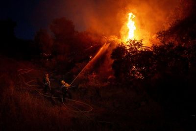 Thousands under evacuation orders in southern California as wildfire threatens homes