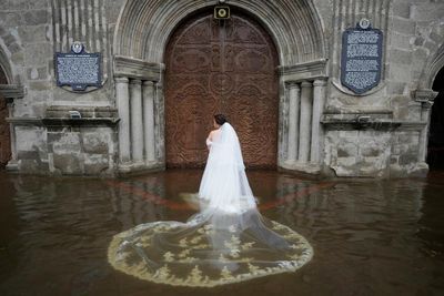 A bride wades through a flood to get married: Aaron Favila’s best photograph
