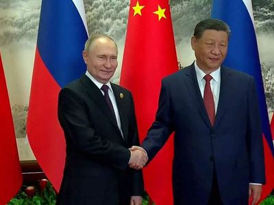 How did Putin and Trump's visits to China compare?
