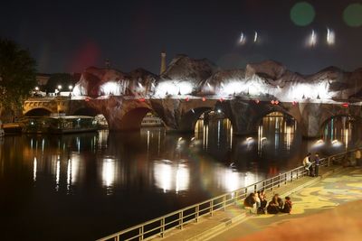 Giant ‘cave’ art inflated over Paris’ oldest bridge in latest work by France’s answer to Banksy