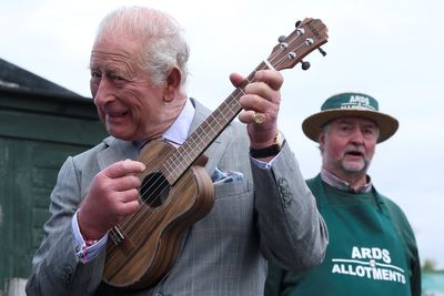 Charles in tune on ukulele as he joins band performing during allotment visit