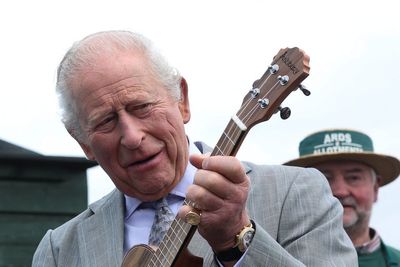 King Charles strums ukulele as he jams with musicians at allotment