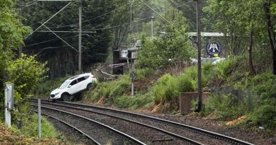 Woman taken to hospital after car crashed onto railway tracks