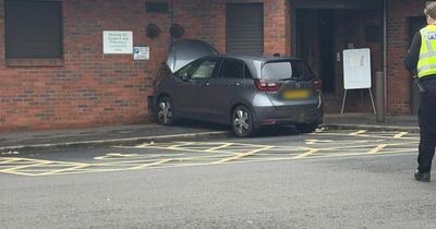 Doctor's surgery locked down and properties evacuated as car crashes into building