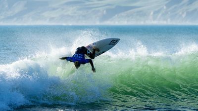 Cibilic flying Australian flag in New Zealand surfing